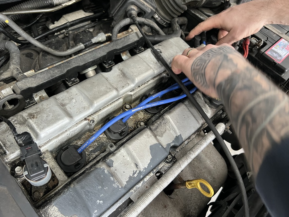 Installing new blue ignition leads to an engine