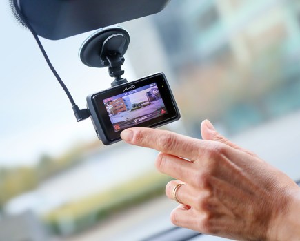 Someone operating a dash cam