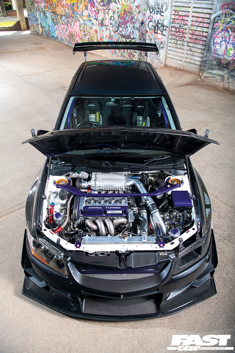 front aerial view of a black Twin-charged-Evo-IX with an open bonet